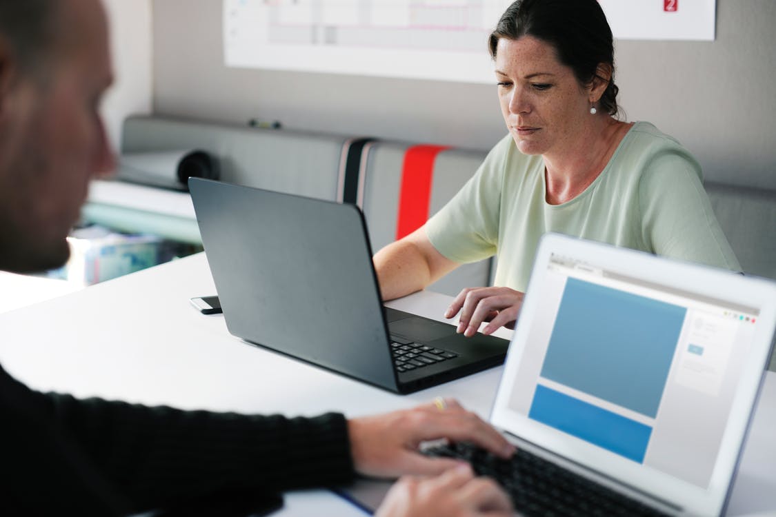 man and woman working on a laptop